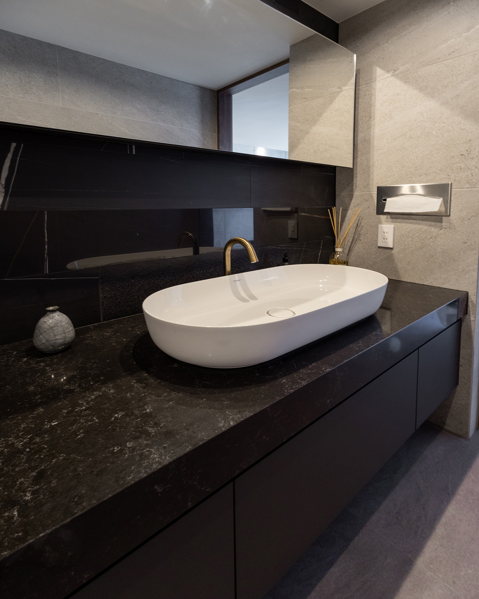 写真：洗練されたダークトーンの洗面空間